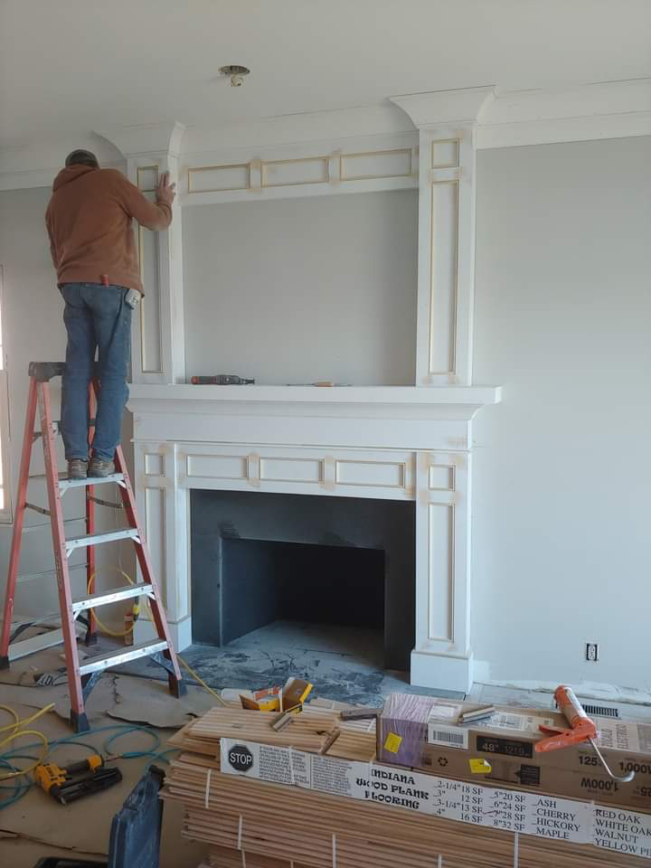 Detailed fireplace surround and decorative trim during installation
